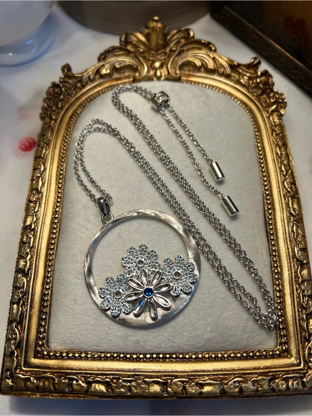 Touchstone Crystal Silver Floral Circle Necklace with Blue Stone
